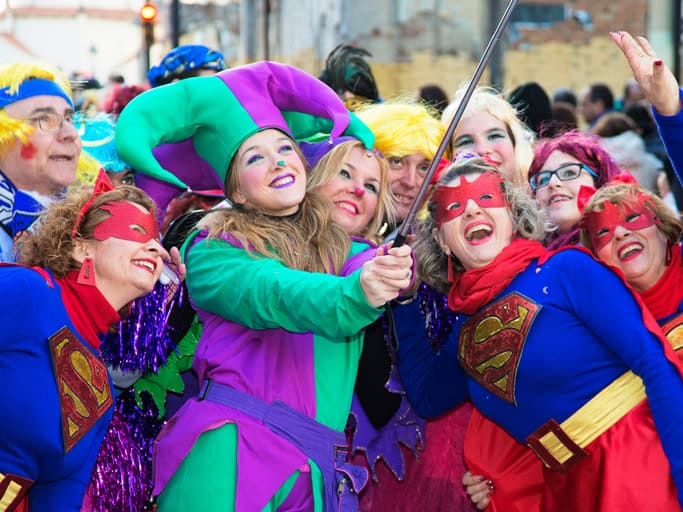 Verkleidete Menschen feiern Karneval und machen gemeinsam ein Selfie